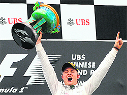  Nico Rosberg of Germany celebrates on the podium after winning the Formula One Chinese Grand Prix at the Shanghai International Circuit on Sunday. 