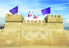 Children stand on a giant sand castle built on Weymouth beach to mark 100 days to go to the London Olympics. 