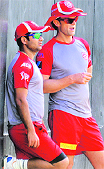Piyush Chawla (L) and Adam Gilchrist during a training session at the PCA Stadium in Mohali on Thursday