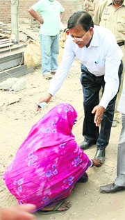 Pasho Devi, whose son lies trapped under the rubble, pleads with the Bihar Deputy Resident Commissioner posted in New Delhi for help.