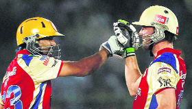 RCB�s Tillakaratne Dilshan and AB de Villiers celebrate a boundary against Rajasthan Royals during their match in Jaipur on Monday.