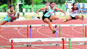 Girls in action at the 100m hurdles event on the concluding day of the 16th Federation Cup National Senior Athletics Championship in Patiala on Tuesday.