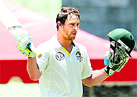 Australian batsman Matthew Wade celebrates as he scores a century during the second day of the third Test against the West Indies in Roseau, Dominica