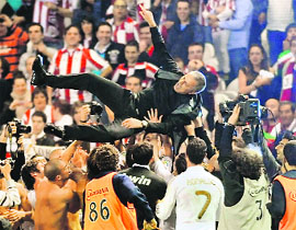 Real Madrid�s players toss coach Jose Mourinho after winning the match against Athletic Bilbao 3-0, on Wednesday. With this win Real won the league title for the first time since 2008. 