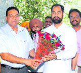 Pawan Kumar Tinu (R) being welcomed by sports department officials in Chandigarh. 