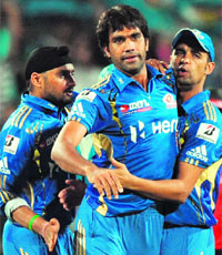 Mumbai Indians� Harbhajan Singh (L) and Robin Peterson (R) congratulate team mate Munaf Patel after taking the wicket of Pune Warriors� Robin Uthappa and Mumbai Indians in Pune on Thursday. Mumbai won by 1 run. 