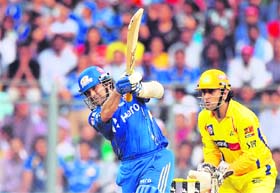 Mumbai Indians� Sachin Tendulkar (L) plays a shot as Chennai Super Kings wicket-keeper Mahendra Singh Dhoni watches at the Wankhede Stadium in Mumbai on Sunday