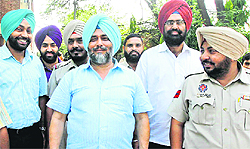 Moga SSP Surjeet Singh Grewal (centre) comes out smiling from the District Courts, Chandigarh, after his acquittal