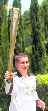 British boxer Alexandros Lucas run with the Olympic flame.