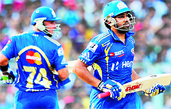 Mumbai Indians� Rohit Sharma (R) and Herschelle Gibbs run between the wickets during their match against Kolkata Knight Riders at the Eden Gardens in Kolkata on Saturday. Rohit scored an unbeaten 109 as Mumbai won the match by 27 runs