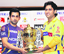 Kolkata captain Gautam Gambhir and Chennai skipper Mahendra Singh Dhoni pose with the IPL-5 trophy in Chennai on Saturday