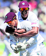 West Indies� Darren Sammy and Denesh Ramdin celebrate after Alastair Cook�s wicket during the second Test at Trent Bridge on Saturday