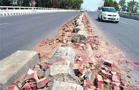 Damaged road divider on the bus stand flyover in Patiala poses a threat to commuters, especially during night