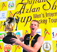New Zealand�s Dean Couzins celebrates with the trophy after winning the Sultan Azlan Shah Cup. 