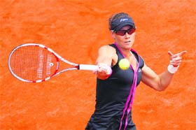 Samantha Stosur hits a return to Dominika Cibulkova during their quaterfinal match at the Roland Garros in Paris on Tuesday