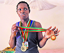 Six-time African champion in women's wrestling, Senegalese Isabelle Sambou, displays her medals after taking part in a training session at the National Centre for Education and Sports (CNEPS), near Dakar. After missing Beijing Olympics in 2008, Sambou, 31, qualified for the London Olympics and is hopeful of winning a medal there