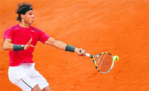 Rafael Nadal hits a return against David Ferrer during their semifinal  in Paris. 