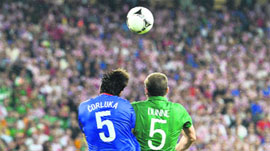 Irish defender Richard Dunne (R) vies with Croatian defender Vedran Corluka during their match at the Municipal Stadium in Poznan on Sunday. Croatia won 3-1.