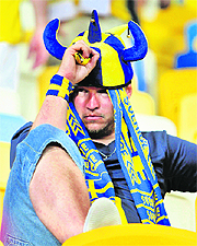 A Sweden fan is despondent after his team lost to Ukraine 2-1 at the Olympic Stadium in Kiev on Monday. 