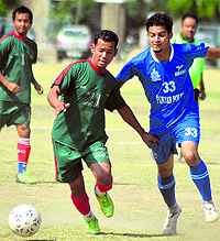 A Gorkha Brigade player vies for the ball with a Punjab Police defender in Mandi on Thursday. Punjab Police won the match 2-1