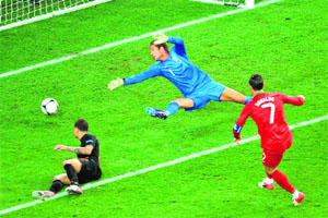 Portuguese forward Cristiano Ronaldo (R) shoots to score past Dutch goalkeeper Maarten Stekelenburg during their match in Kharkiv on Sunday. Portugal won 2-1.