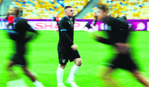 English forward Wayne Rooney (C) during a training session at the Olympic stadium in Kiev. Rooney is set to play against Ukraine after a 2-match ban.