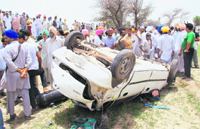 The mangled remains of the car which was hit by a train near Akalia village in Bathinda on Thursday. Tribune photo: Pawan Sharma