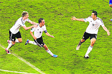 Germany�s Philipp Lahm (C) is congratulated by teammates Marco Reus (L) and Miroslav Klose after scoring the opening goal during their match against Greece in Gdansk on Friday. Germany won 4-2. 