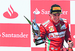 Ferrari's Spanish driver Fernando Alonso celebrates on the podium at the Valencia Street Circuit. 