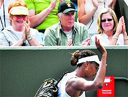 Venus Williams of the US leaves the court after being defeated by Elena Vesnina of Russia