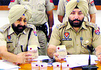 Police officials show the seized heroin in Patiala on Wednesday