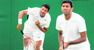 Mahesh Bhupathi serves during his first round doubles match with Rohan Bopanna (R) against Marcel Feldeon and Malek Jaziri at the All England Tennis Club in Wimbledon on Wednesday. The Indian duo won 6-0, 7-6, 6-2. 
