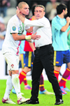 Portuguese defender Pepe is comforted by head coach Paulo Bento after they lost to Spain. � AFP 