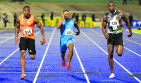 Jamaican sprinter Yohan Blake (L) runs for the victory before Micheal Frater (C) and Usain Bolt (R) in the 100m men's final of the Jamaican Olympic Athletic Trials in Kingston on Friday.