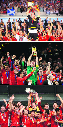 A combination of pictures shows (top to bottom) Spanish goalkeeper and captain Iker Casillas holding the 2008 Euro Championship trophy in Vienna, the 2010 World Cup trophy in Johannesburg and the 2012 Euro Championship trophy on Sunday in Kiev.