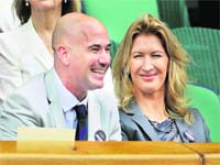 Former champions Andre Agassi and Steffi Graf watch Roger Federer in action on Wednesday