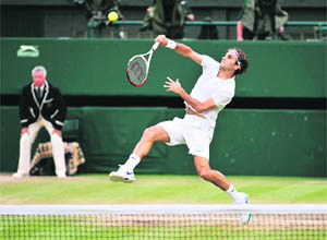 Roger Federer hits a smash during the men's singles semifinals against Serbia's Novak Djokovic at Wimbledon in London on Friday. 