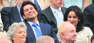 Sachin Tendulkar with his wife Anjali (right) watch the semifinal between Roger Federer and Novak Djokovic from the Royal Box at  Wimbledon on Friday. 