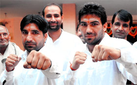 Olympics-bound boxer Manoj Kumar (right) and his brother pose after a one-day yagna organised by his family in Kurushetra on Sunday.