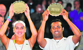 Elena Vesnina and Leander Paes hold up their runners-up trophies after their mixed doubles final defeat to Mike Bryan and Lisa Raymond on Sunday.