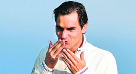 Roger Federer blows kisses to fans on a walkway leading to the clubhouse after his final victory over Andy Murray on Sunday.