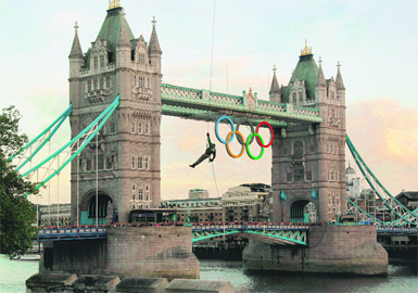 A Royal Marine abseils from a copter hovering over the River Thames, carrying the Olympic flame to the ground in a lantern hanging from his belt