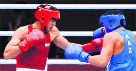 Vijender Singh of India (L) goes on the offensive against Danabek Suzhanov of Kazakhstan during their first round (75Kg) bout at the ExCel Arena on Saturday night