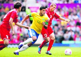 Brazil's Hulk fights for the ball with Belarus' Mikhail Gordeichuk (R) on Sunday. Brazil won 3-1