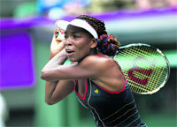 Venus Williams of the US returns the ball to Canada's Aleksandra Wozniak in Wimbledon on Tuesday. � AFP