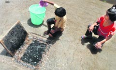 Children fill water from a leaking supply line in Patiala and (below) a broken water pipe near the Ludhiana Civil Hospital. Tribune file photos