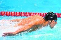 Michael Phelps competes in the men's 100m butterfly on Friday. Phelps won the Gold, his 21st Olympic medal. � AFP 