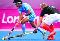 Shivendra Singh vies with a German player on Friday. � AFP