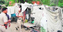 Police officials at the victim�s kiosk in Amritsar on Saturday. Photo: Sameer Sehgal