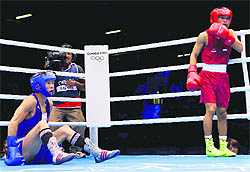 Devendro Singh (R) knocks down Serdamba Purevdorj of Mongolia on Saturday